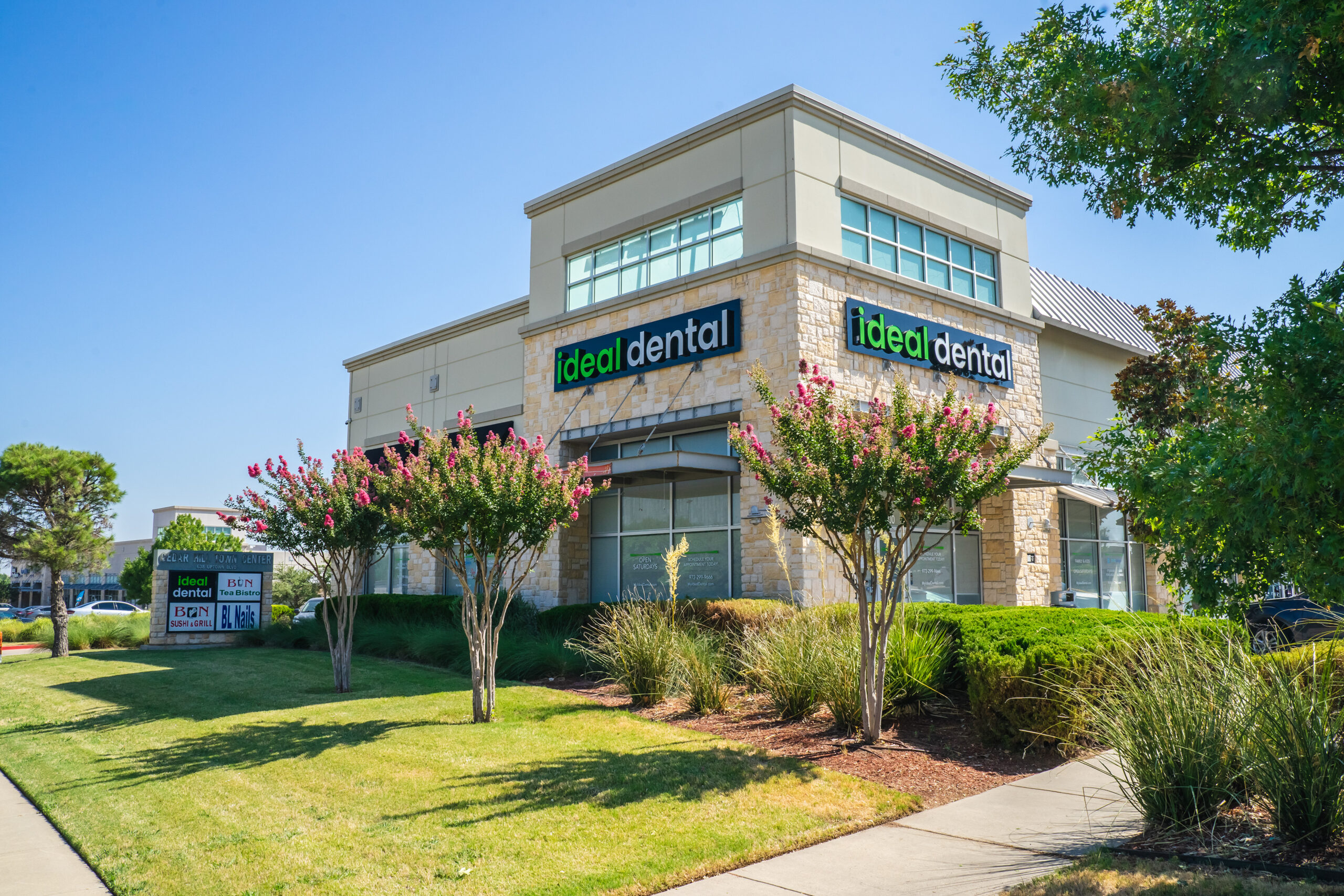 Ideal Dental office building exterior with flowering trees